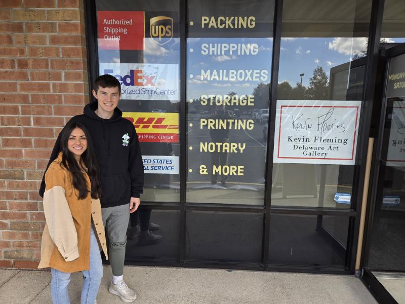 Zach Gaudlip and his wife Angela stand in front of their store, Milton Mail Boxes, in the Food Lion Shopping Center. JEFF SEEMANS PHOTO